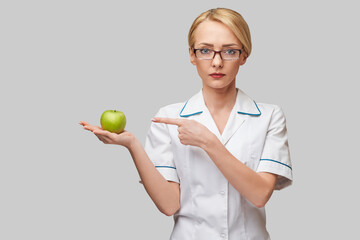 nutritionist doctor healthy lifestyle concept - holding organic fresh green apple