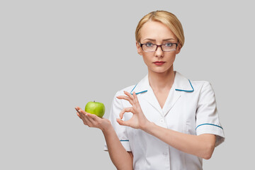 nutritionist doctor healthy lifestyle concept - holding organic fresh green apple