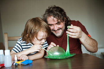 Father and son make slime at home. Homemade experiments.