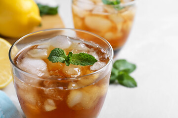 Delicious iced tea in glass on light table, closeup. Space for text