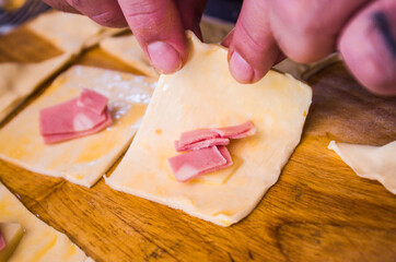 preparation of pretzels with cheese and mortadella cooked in the oven