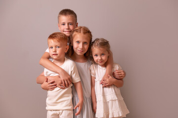 brothers and sisters. children hug. 4 children. large family