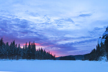 Winter landscape, rocks and forest, beautiful sky, at sunset, Siberia.