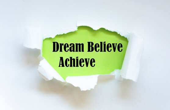 Naklejki Dream Believe Achieve. Words written under torn paper. Motivation concept text.
