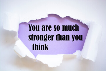 You are so much stronger than you think. Words written under torn paper. Motivation concept text.