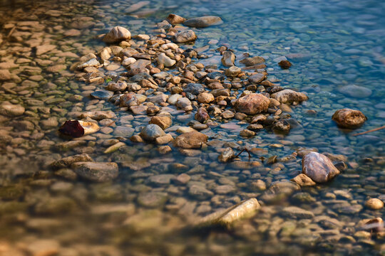 Some rocks into the river. Stones wallpaper texture. Some wet stones in the river bed