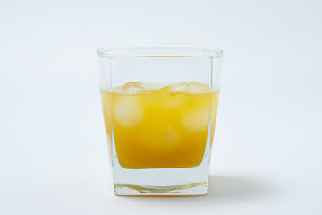 Juice with ice in a glass on a white background. Natural mango juice. Refreshing drink
