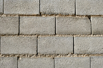 Wall made of grey concrete bricks. Bricks background and texture