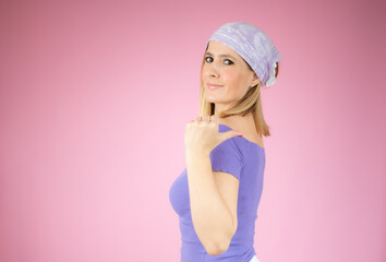 Young woman over isolated pink background pointing finger to the side