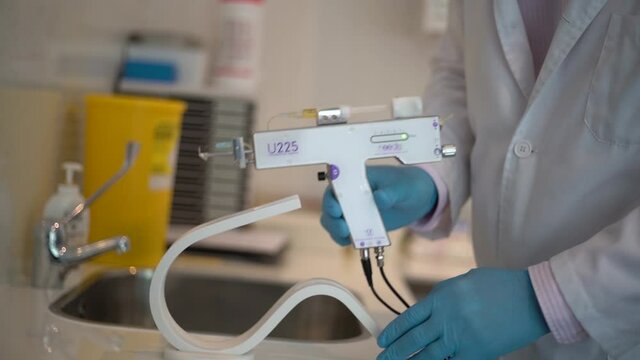 Medium shot of male doctor taking mesotherapy syringe gun.