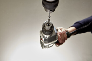 Using glass drill to drilling hole in mirror surface.