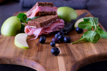 Blueberries with sandwich on a wooden board Selective focus