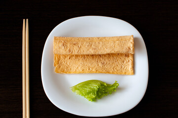 Natural diet food for vegetarians in a white plate on a black background
