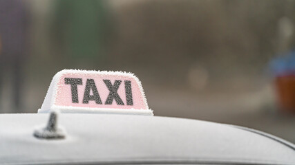 Frosty taxi sign on the roof of a car