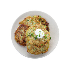 Delicious zucchini fritters with sour cream on white background, top view