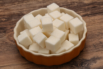 Refined white sugar cubs in the bowl