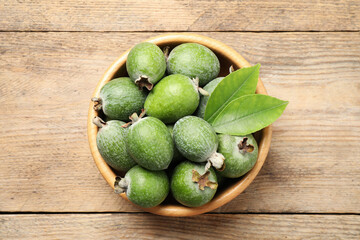 Top view of fresh green feijoa fruits in bowl on wooden table
