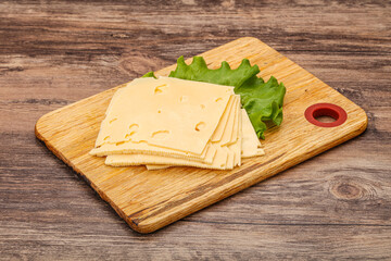 Sliced yellow cheese over board