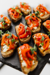 Sandwiches with cheese and vegetables close-up on a buffet table.