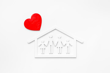 Family figure in wooden house with heart shape. Happy family, protection concept