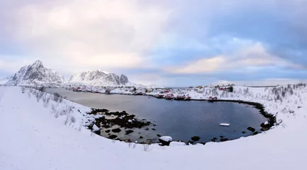 Wall murals Reinefjorden Beautiful village of Reine in Lofoten Islands, Norway. Snow covered winter landscape at sunset. Amazing tourist attraction in the polar circle. Panoramic view.