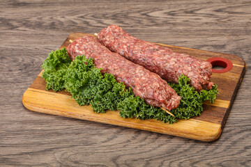 Raw minced beef kebab skewer