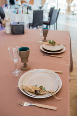 Festive table setting in the restaurant, wine glass and plate.