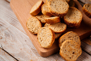 Closeup on pile of dried bread crackers on the wooden background