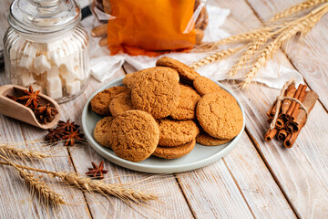 Pile of spicy oatmeal cookies on wooden decorated background