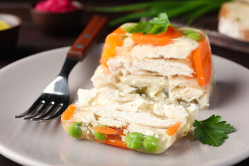 Delicious chicken aspic with vegetables on plate, closeup