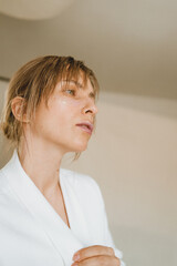 Sensual portrait of a young attractive woman in a white blazer.