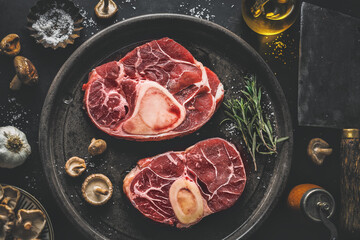 Raw meat with vegetables on table