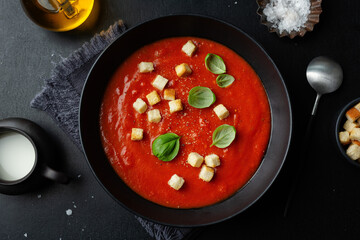 Creamy tomato soup served in bowl