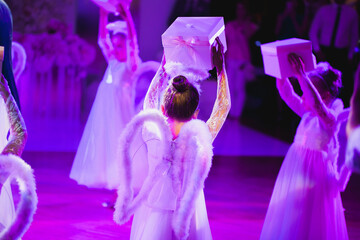 Little children dressed as an angel dancing at the wedding Banquet.