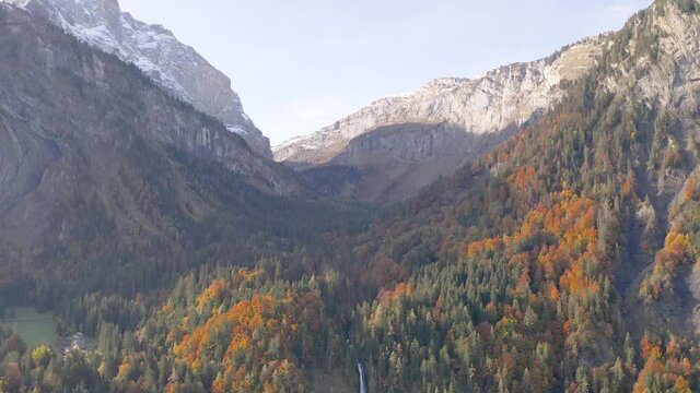 Picturesque Landscape Of Cascade du Rouget With Autumn Forest In Sixt-Fer-a-Cheval, France. - aerial tilt down