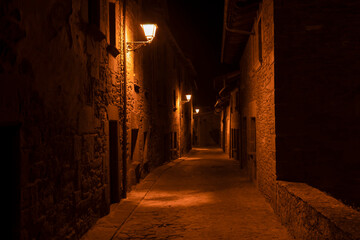 Amazing night view of old stone street with lamps lighting in ancient medieval village of Rupit ,...