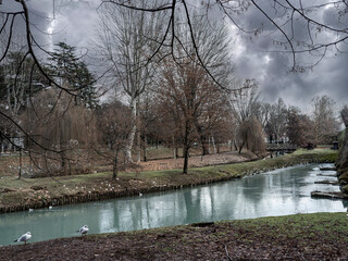 Park with river around the walls of Treviso, a historic town in Italy 