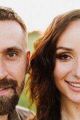 Close-up of a man and woman looking into the camera.