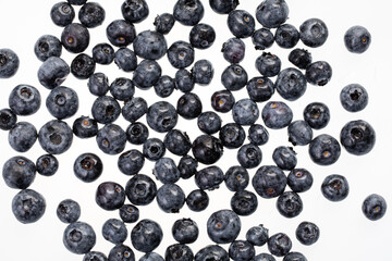 fresh blueberries spread on white surface 