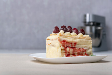 Piece of vanilla slice cake, fruit syrup and berries. Close up.
