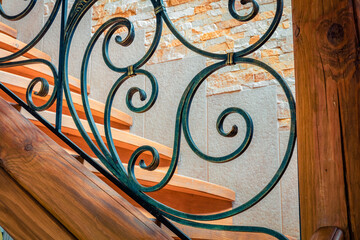 Elements of wrought iron railings and wooden stairs in a mountain chalet in the Carpathians.