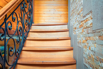 Elements of wrought iron railings and wooden stairs in a mountain chalet in the Carpathians.