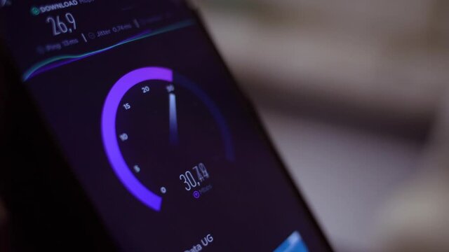 Smartphone screen with internet speed test running. Shallow depth of field. Close up.