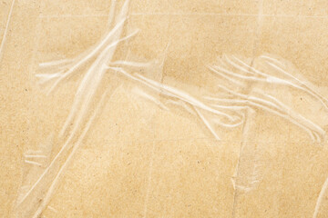 transparent adhesive tape on old brown cardboard paper background