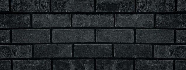 Black shabby brick wall close-up wide texture. Dark grey brickwork grunge widescreen background