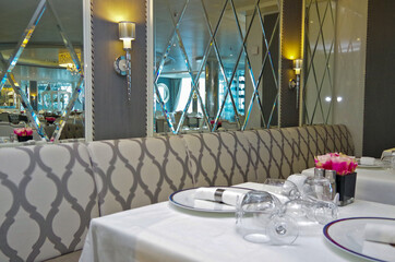 Elegant formal dining room or restaurant onboard luxury cruiseship or cruise ship liner in white...