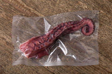 fresh octopus tentacle in vacuum sealed packaging  