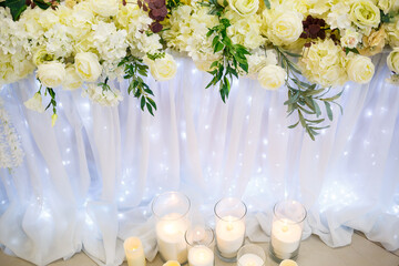 Wedding decor made of flowers and fabric. Beautiful decorations for newlyweds on their wedding day