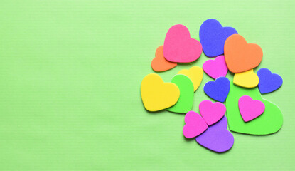 Hearts of various colors, Valentine's Day, love, special days. Light green background. Copy space.