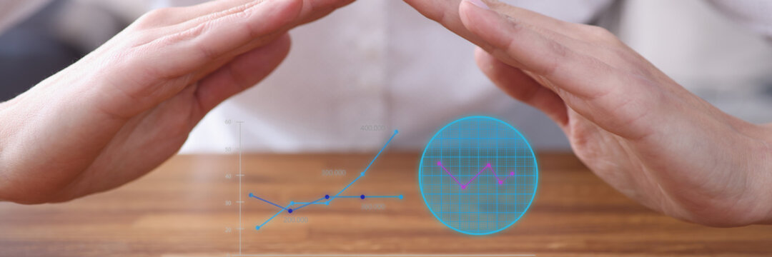 Virtual sales figures above the table in hand area. Small and medium business development concept